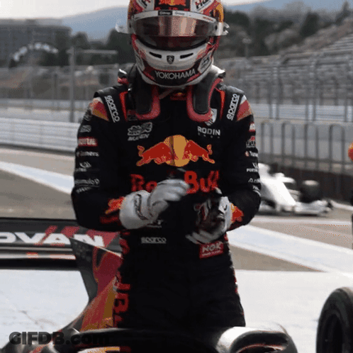 A Man Wearing A Red Bull Helmet And A Yokohama Jacket GIF