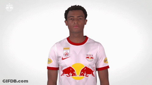 A Man Wearing A Red Bull Jersey Holds His Hands Up GIF