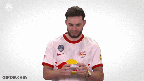 A Man Wearing A Red Bull Jersey Is Clapping GIF