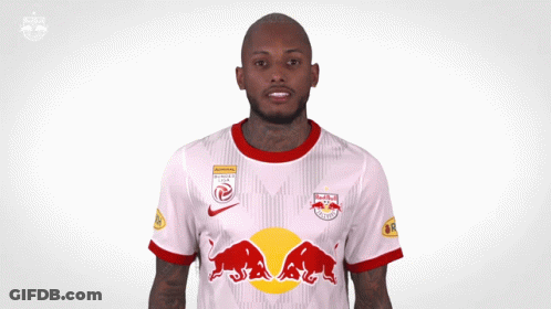 A Man Wearing A Red Bull Jersey Is Making A Funny Face GIF
