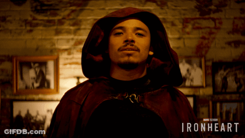 A Man Wearing A Red Cape With The Words Ironheart On The Bottom GIF