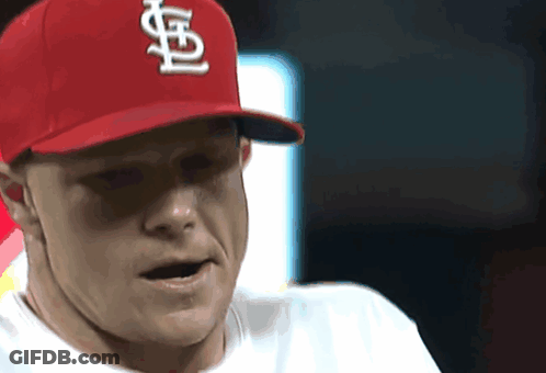 A Man Wearing A Red Cardinals Hat Looks To His Left GIF