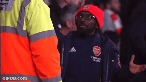A Man Wearing A Red Hat And A Black Jacket With Emirates Fly Better Written On It GIF