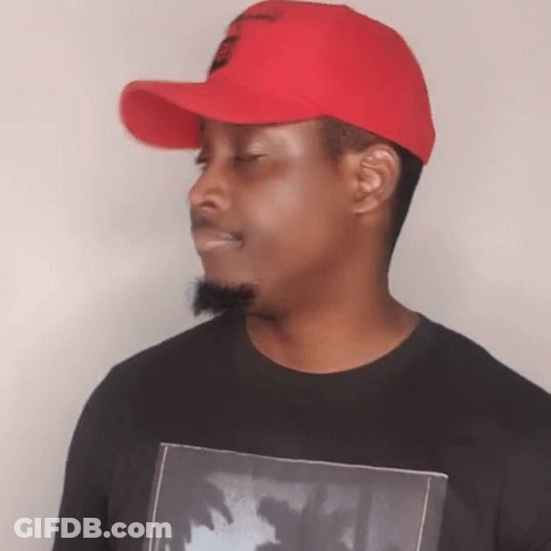 A Man Wearing A Red Hat And A Black Shirt With A Picture Of Palm Trees GIF