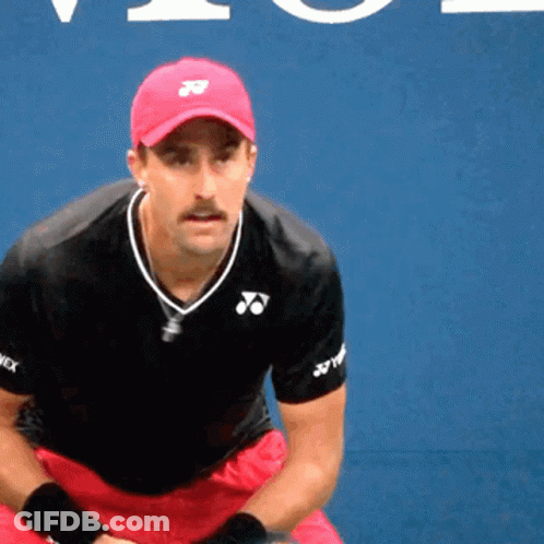 A Man Wearing A Red Hat And A Black Shirt With Yonex Written On The Sleeves GIF