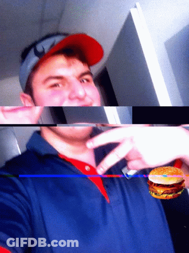 A Man Wearing A Red Hat And A Blue Shirt Holds A Hamburger GIF