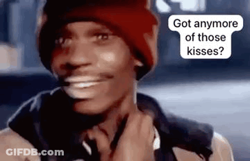 A Man Wearing A Red Hat And A Jacket Is Smiling And Talking On A Cell Phone . GIF