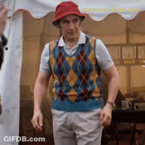 A Man Wearing A Red Hat And A Plaid Vest Is Standing In Front Of A White Tent .. GIF