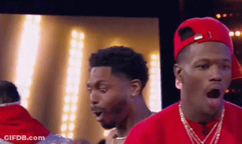 A Man Wearing A Red Hat And A Red Shirt Has His Mouth Open GIF