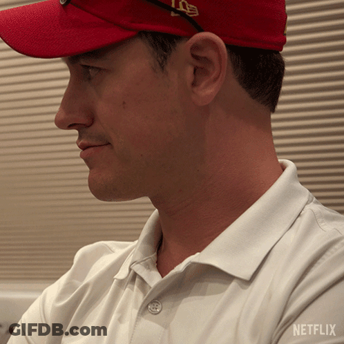 A Man Wearing A Red Hat And A White Shirt With Netflix On The Bottom GIF