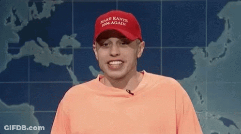 Man In Red Hat And Orange Shirt Smiling By Map GIF