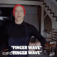 A Man Wearing A Red Hat And Overalls Says " Finger Wave " GIF