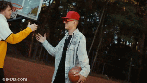 A Man Wearing A Red Hat And Sunglasses Is Holding A Spalding Basketball GIF