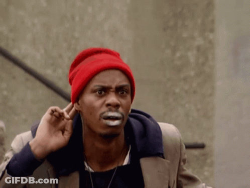A Man Wearing A Red Hat Is Covering His Ears GIF