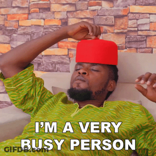 A Man Wearing A Red Hat Is Laying On A Couch With The Words I 'M A Very Busy Person Above Him GIF