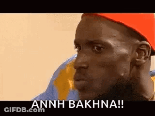 A Man Wearing A Red Hat Is Making A Funny Face And Says Annh Bakhna ! GIF