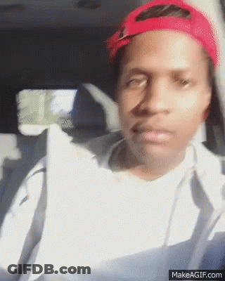 A Man Wearing A Red Hat Is Sitting In The Back Seat Of A Car GIF