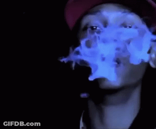 A Man Wearing A Red Hat Is Smoking A Cigarette With Blue Smoke Coming Out Of His Mouth . GIF