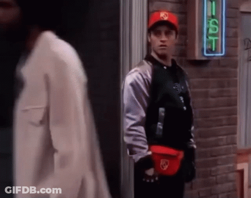 A Man Wearing A Red Hat Is Standing In Front Of A Sign That Says Gst GIF