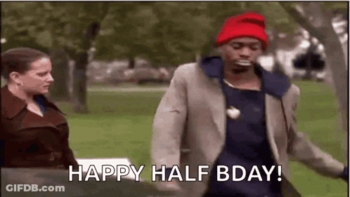 A Man Wearing A Red Hat Is Walking In A Park With A Woman . GIF