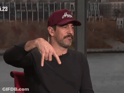 A Man Wearing A Red Hat That Says Hugs On It GIF