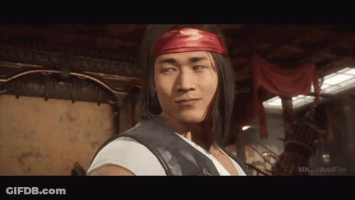A Man Wearing A Red Headband And A White Shirt Is Standing In A Room .. GIF