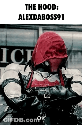 A Man Wearing A Red Hood Is Standing In Front Of A Building . GIF