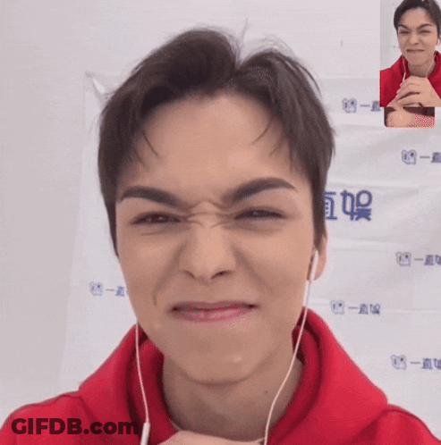 A Man Wearing A Red Hoodie Is Making A Face GIF