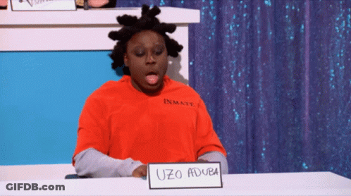 A Man Wearing A Red Inmate Shirt Is Sitting At A Table GIF