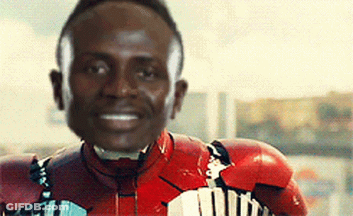 A Man Wearing A Red Iron Man Suit Is Smiling GIF