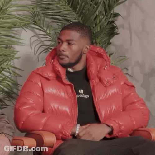 A Man Wearing A Red Jacket And A Balenciaga Shirt GIF
