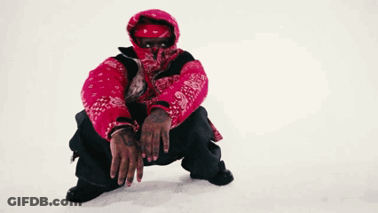 A Man Wearing A Red Jacket And A Bandana On His Face Is Squatting Down In The Snow . GIF