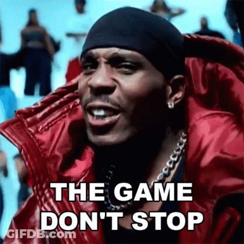 A Man Wearing A Red Jacket And A Black Headband Is Singing The Game Don 'T Stop . GIF