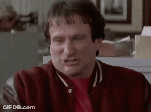 A Man Wearing A Red Jacket And A Red Shirt Is Making A Face . GIF