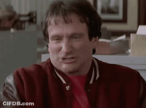 A Man Wearing A Red Jacket And A Red Shirt Is Making A Funny Face GIF