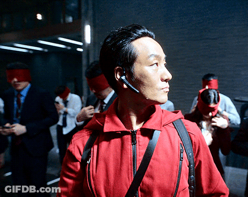 A Man Wearing A Red Jacket Has A Headset On GIF