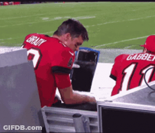 A Man Wearing A Red Jersey That Says Brady On The Back GIF