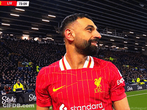 A Man Wearing A Red Jersey That Says Standard On The Front GIF
