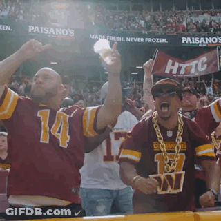 A Man Wearing A Red Jersey With The Number 14 On It Is Cheering GIF