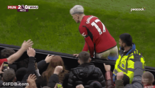 A Man Wearing A Red Jersey With The Number 17 On The Back GIF
