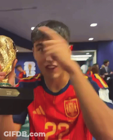 A Man Wearing A Red Jersey With The Number 22 On It Holds A Trophy GIF
