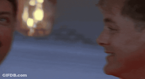 A Man Wearing A Red Life Jacket With A White Stripe On The Bottom GIF