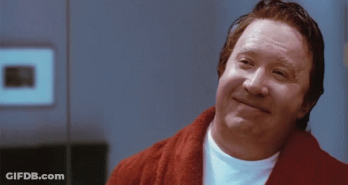A Man Wearing A Red Robe And A White Shirt Is Smiling GIF