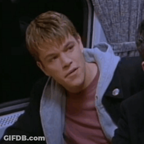A Man Wearing A Red Shirt And A Black Jacket Is Looking At Something GIF