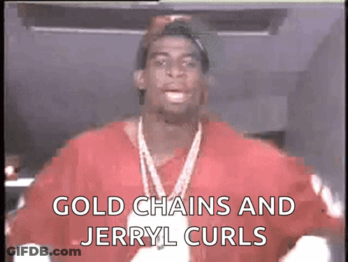 A Man Wearing A Red Shirt And Gold Chains Says Gold Chains And Jerry L Curls GIF