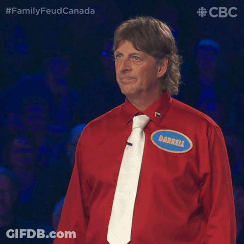 A Man Wearing A Red Shirt And Tie Has A Name Tag That Says Darrell GIF