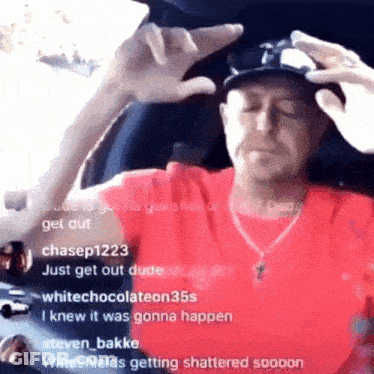 A Man Wearing A Red Shirt Is Sitting In A Car With His Eyes Closed GIF
