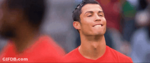 A Man Wearing A Red Shirt Is Smiling And Looking Up GIF