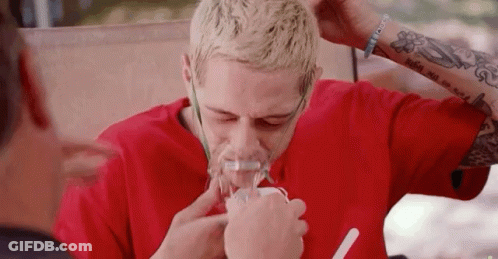A Man Wearing A Red Shirt Is Using An Oxygen Mask GIF