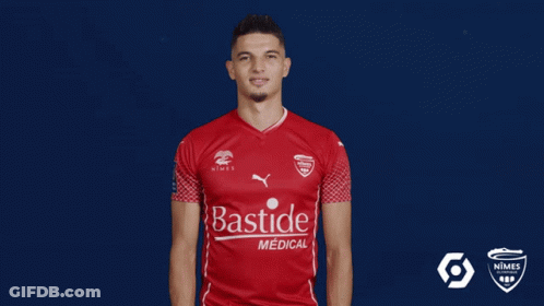 A Man Wearing A Red Shirt That Says Bastide Medical On It GIF